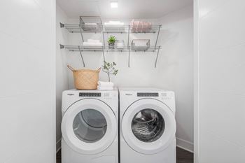 a washer and dryer in a laundry room with white walls